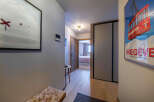 Step into this inviting hallway, featuring a blend of modern design and warm, natural elements.