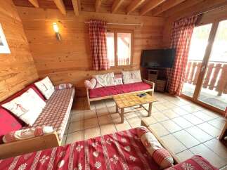This cozy living space features beautiful wooden paneling and comfortable seating, perfect for relaxing after a day of outdoor adventures.