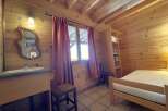 Step into this charming cabin retreat, featuring warm wooden interiors and a cozy atmosphere.