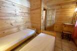 Discover the charm of this cozy cabin featuring two comfortable beds, perfect for a relaxing getaway.