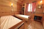 This cozy cabin bedroom features two twin beds, perfect for a comfortable stay.
