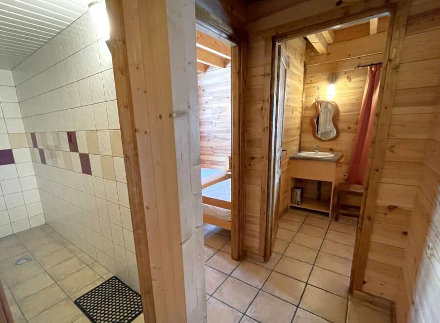 Discover the charm of this cozy property, featuring a well-designed bathroom with tiled walls and a separate shower area.