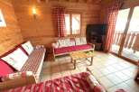 This cozy living space features beautiful wooden paneling and comfortable seating, perfect for relaxing after a day of outdoor adventures.