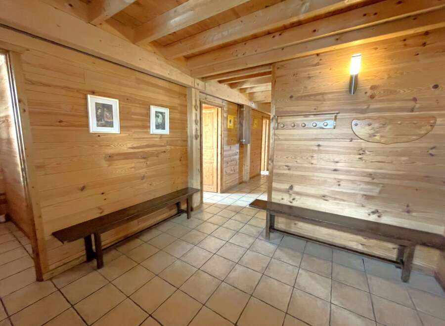 Step into this inviting space, featuring warm wooden walls and a cozy atmosphere.