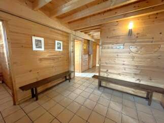 Step into this inviting space, featuring warm wooden walls and a cozy atmosphere.