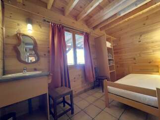 Step into this charming cabin retreat, featuring warm wooden interiors and a cozy atmosphere.