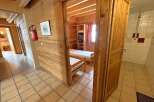 Step into this charming property featuring a cozy bedroom with wooden accents and a comfortable bed.