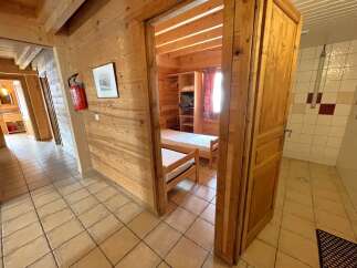 Step into this charming property featuring a cozy bedroom with wooden accents and a comfortable bed.