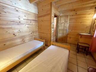 Discover the charm of this cozy cabin featuring two comfortable beds, perfect for a relaxing getaway.