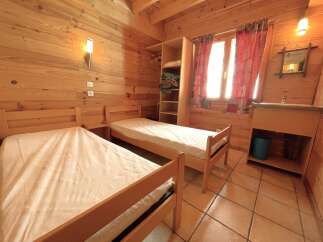 This cozy cabin bedroom features two twin beds, perfect for a comfortable stay.