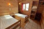 This cozy bedroom features two single beds, perfect for a comfortable stay.