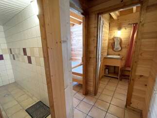 Discover the charm of this cozy property, featuring a well-designed bathroom with tiled walls and a separate shower area.