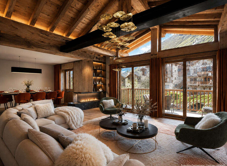 Experience luxurious alpine living in this stunning mountain retreat, featuring a grand living area with a modern fireplace and expansive windows showcasing breathtaking village and mountain views.