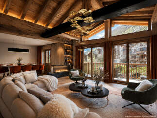 Experience luxurious alpine living in this stunning mountain retreat, featuring a grand living area with a modern fireplace and expansive windows showcasing breathtaking village and mountain views.
