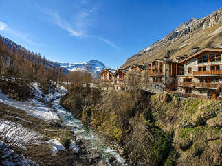 Experience luxury mountain living in this stunning alpine property, featuring traditional stone and wood architecture that blends seamlessly with the natural landscape.