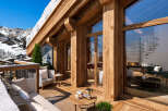 Experience luxury mountain living in this stunning chalet, featuring expansive wooden beams and floor-to-ceiling windows that offer breathtaking alpine views.