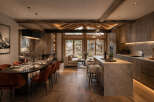 Experience luxurious mountain living in this stunning open-concept space, featuring a gourmet kitchen with a marble island and a sophisticated dining area perfect for entertaining.