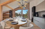 Experience luxury living in this stunning property, featuring a modern kitchen and a dining area with breathtaking mountain views.