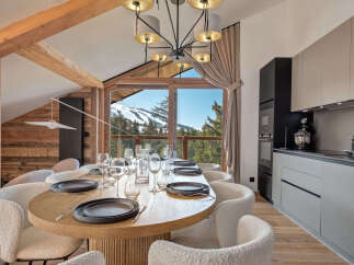 Experience luxury living in this stunning property, featuring a modern kitchen and a dining area with breathtaking mountain views.
