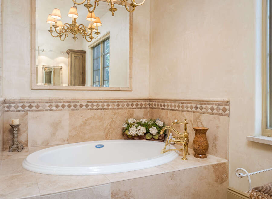 Indulge in luxury with this stunning bathroom featuring a beautiful soaking tub.