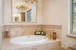 Indulge in luxury with this stunning bathroom featuring a beautiful soaking tub.