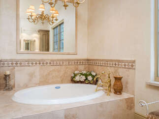 Indulge in luxury with this stunning bathroom featuring a beautiful soaking tub.