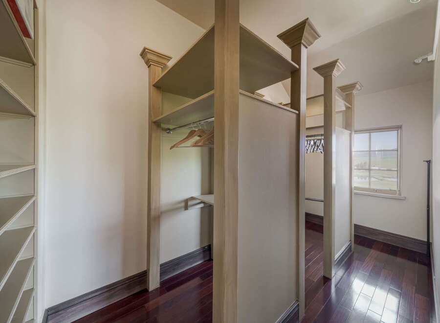Step into luxury with this stunning walk-in closet, designed for both style and functionality.