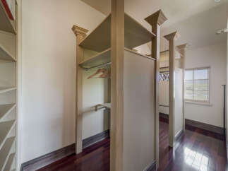 Step into luxury with this stunning walk-in closet, designed for both style and functionality.