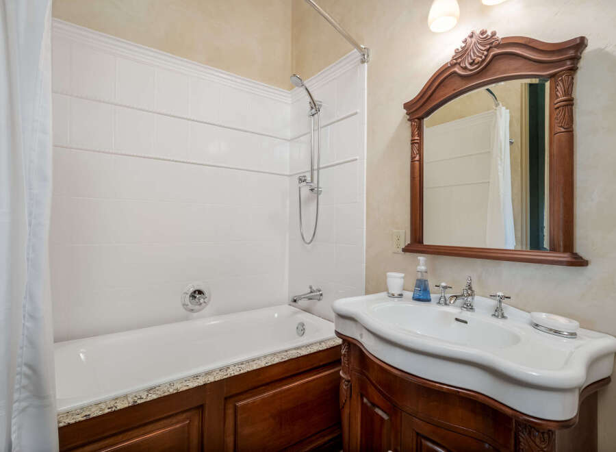 Step into this elegant bathroom featuring a classic design and luxurious finishes.
