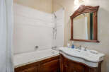 Step into this elegant bathroom featuring a classic design and luxurious finishes.