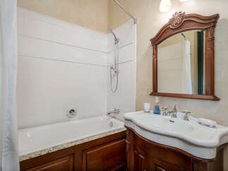 Step into this elegant bathroom featuring a classic design and luxurious finishes.