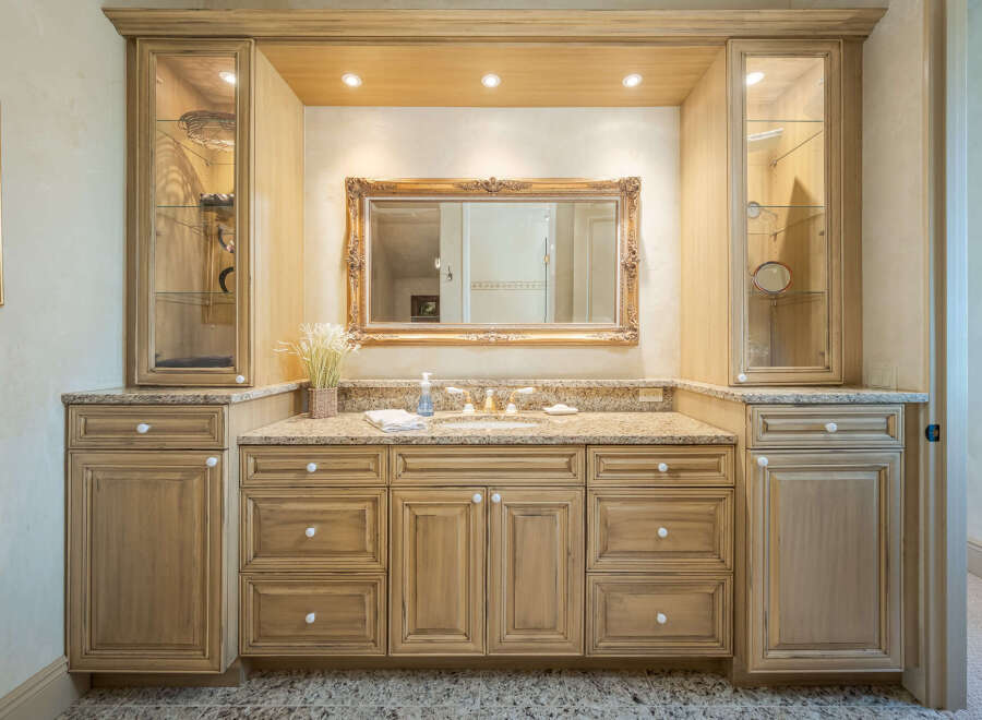 This stunning bathroom boasts a luxurious vanity with ample storage and a beautiful granite countertop.