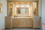 This stunning bathroom boasts a luxurious vanity with ample storage and a beautiful granite countertop.