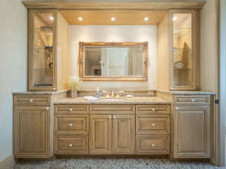 This stunning bathroom boasts a luxurious vanity with ample storage and a beautiful granite countertop.