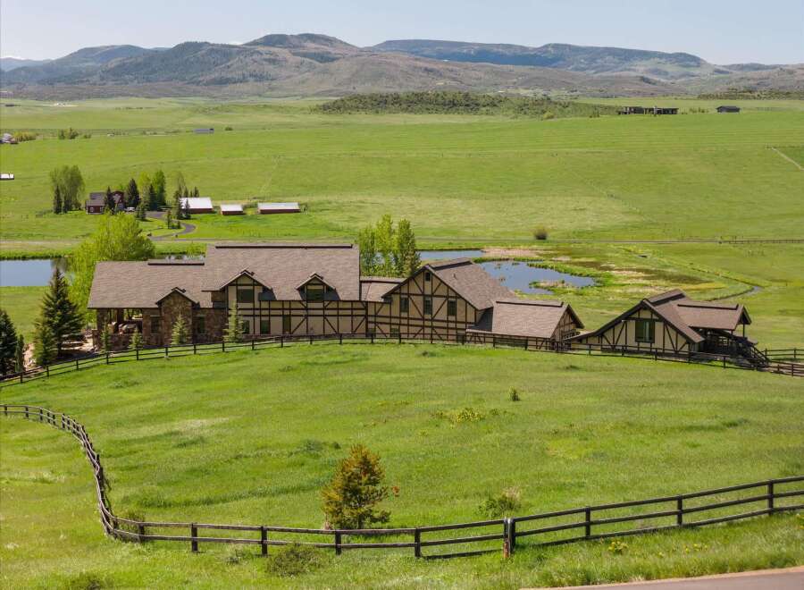 Nestled amidst rolling green hills and picturesque ponds, this expansive estate offers a serene countryside retreat.