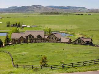 Nestled amidst rolling green hills and picturesque ponds, this expansive estate offers a serene countryside retreat.