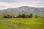 Experience luxury mountain living in this stunning estate, featuring a grand stone-clad main residence and a charming guest house.