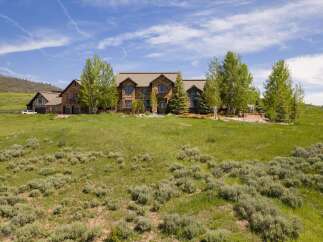 Experience luxury mountain living in this stunning stone estate, nestled on a sprawling hillside with panoramic views.