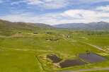 Experience the breathtaking beauty of this expansive ranch, featuring rolling green hills and majestic mountain vistas.