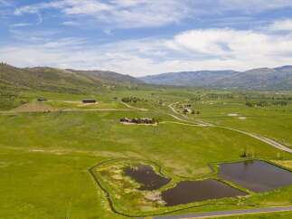 Experience the breathtaking beauty of this expansive ranch, featuring rolling green hills and majestic mountain vistas.
