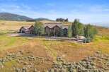 Nestled in a picturesque landscape, this expansive estate offers a luxurious stone-clad residence with multiple wings and a charming Tudor-style guest house.