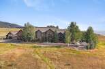 Experience luxury mountain living in this stunning stone estate, nestled amidst rolling hills and mature trees.