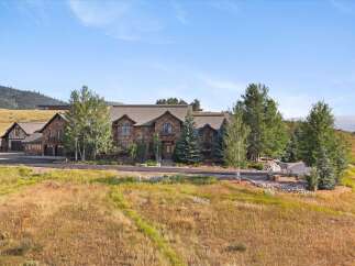 Experience luxury mountain living in this stunning stone estate, nestled amidst rolling hills and mature trees.