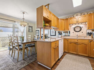 Step into this inviting kitchen, featuring warm wooden cabinetry and a functional layout.