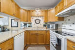This charming kitchen boasts beautiful wooden cabinetry and a functional layout, perfect for culinary enthusiasts.