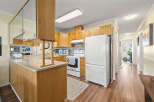 Step into this inviting kitchen, featuring warm wood cabinetry and a functional layout.