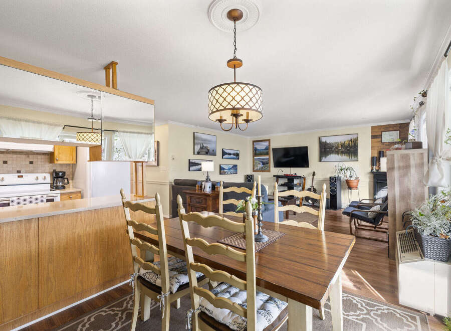 Step into this inviting home featuring a seamless blend of dining and living spaces.