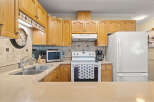 This charming kitchen boasts warm wooden cabinetry, offering ample storage and a classic aesthetic.