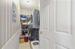 Discover the convenience of this well-organized laundry room! Featuring a stacked washer and dryer, this space maximizes functionality.