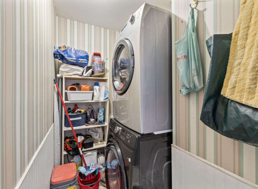 Discover the convenience of this well-organized laundry room, featuring a modern washer and dryer set.